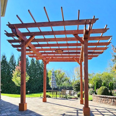 Round Pergola (Options: 16' Diameter, No Privacy Panel, California Redwood, Open Roof Slats at 18", 9ft Post Height, Include Electrical Wiring Trim for 2 Posts, 4-Post Anchor Kit for Concrete, No Post Decorative Trim, 1 Ceiling Fan Base, No Curtain Rods, Transparent Premium Sealant). Photo courtesy of J. Holobinko of Hagerstown, MD.