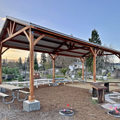 San Carlos Carport Pavilion (Options: 40' L x 20' W, Mosaic Redwood, 6- Post Stainless Steel High Wind Anchor Kit, 10' H Posts, 6x6 Posts, Electrical Wiring Trim Kit for 1 Post, Transparent Premium Sealant). Order installed at Bayer Park Gardens, 1550 West Ave. Santa Rosa, CA.