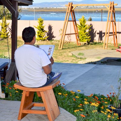 Sanctuary Wood Patio Bench (Options: Douglas-fir, No Engraving, Transparent Premium Sealant). Photo also shows a Rory's Giant Swing Set in background.