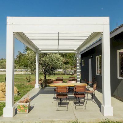 Silverado Modern Pergola (Options: 20' L, 10' W, Standard Roof Style, 12" Roof Rafter Spacing, Mosaic Redwood,  4-Post Anchor kit for Concrete, White Primer). 
