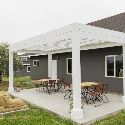 Silverado Modern Pergola (Options: 20' L, 10' W, Standard Roof Style, 12" Roof Rafter Spacing, Mosaic Redwood,  4-Post Anchor kit for Concrete, White Primer). 