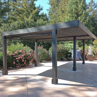 Silverado Modern Pergola (Options: 24' L, 16' W, 6" Roof Rafter Spacing, Mosaic Douglas-fir, Cantilevered Roof Style, 2 Ceiling Fan Bases, 2 Electrical Wiring Trim Kits, 3 Curtain Rods, Black Stain Premium Sealant). Photo Courtesy of D. Amadia of Santa Cruz, CA.