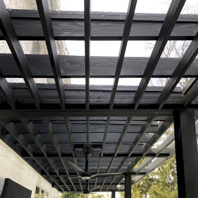 Custom Attached Silverado Modern Pergola (Options: 36' L, 10' W, Cantilevered Roof Style, 12" Roof Rafter Spacing, California Redwood, 2 Ceiling Fan Bases, 4-Post Anchor kit for Concrete, Black Stain Premium Sealant). Photo Courtesy of A. Papantomiou of Manhasset, New York.