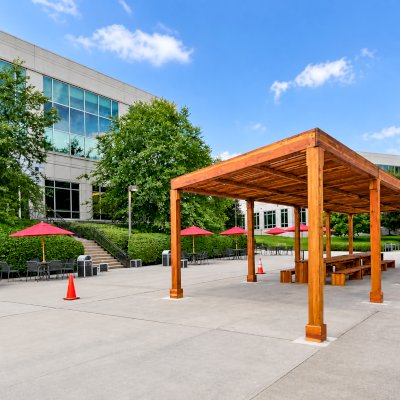 Silverado Modern Pergola (Options: 58' L, 16' W, Standard Roof Style, California Redwood, No Electrical Wiring Trim, with 1 3/4" x 11 1/4" Roof Support Timbers and 7 1/4" x 7 1/4" Posts, Post Anchor Kit for Concrete, No Privacy Panels, No Curtain Rods, 10' Post Height, Transparent Premium Sealant). Photo Also Shows 2 Maynard Modern Redwood Patio Table Sets Under the Pergola. Photo Courtesy of A. Arena of Morristown, New Jersey.