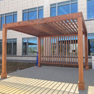 Silverado Modern Pergola (Options: 16' L, 16' W, Standard Roof Style, 8" Roof Rafter Spacing, California Redwood,  10.5' H Posts, 4-Post Anchor kit for Concrete, with 1 Custom Panel, Transparent Premium Sealant). Photo Courtesy of S. Barragan of Milpitas, California.