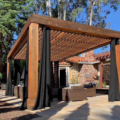 Silverado Modern Pergola (Options: 7 1/4" x 7 1/4" Post Thickness, Standard Roof Style, 20'L x 14'W, No Privacy Panels, California Redwood, No Rain Guard, 9ft Post Height, No Electrical Wiring Trim, 4 Post Anchor Kit for Concrete, 4 Curtain Rods, No Ceiling Fan Base, Transparent Premium Sealant). Photo Courtesy of B. Walsh of Atherton, California.