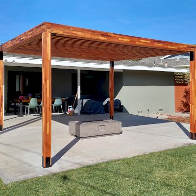 Silverado Modern Pergola (Options: 16' L, 14' W, Mosaic Redwood, 1 Electrical Wiring Trim, Standard Roof Style, Roof Rafter Spacing at 6", 4 Post Anchor Kit for Concrete, No Privacy Panels, No Curtain Rods, 9' Post Height, Transparent Premium Sealant). Photo Courtesy of C. Rolls of Ventura, CA.