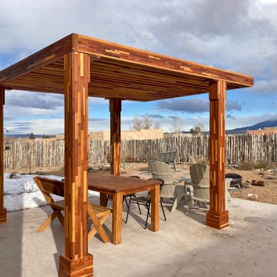 Silverado Modern Pergola (Options: 12' L, 10' W, 6" Roof Rafter Spacing, Mosaic Redwood, 8x8 Posts, Cantilevered Roof Style, No Ceiling Fan Base, No Electrical Wiring Trim Kits, No Curtain Rods, Transparent Premium Sealant). Photo Courtesy of D. Asmus of Taos, NM.