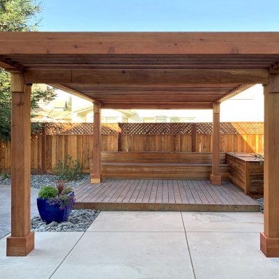Silverado Modern Pergola (Options: 20' L, 12' W, California Redwood, Cantilevered Roof Style [3' On One Side and 2' On the Other Side], No Electrical Wiring Trim, with 1 3/4" x 9 1/4" Roof Support Timbers and 7 1/4" x 7 1/4" Posts, Roof Rafter Spacing at 6", 4 Post Anchor Kit for Concrete, No Privacy Panels, 1 Curtain Rod and 2 Fascia Boards, 9' Post Height, Transparent Premium Sealant). Photo highlights the double cantilever customization requested. Photo Courtesy of K. Maki of Oakdale, CA.