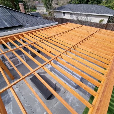Custom Silverado Modern Pergola (Options: 20' L, 15' W, 8" Overhang on 2 Sides, Douglas-Fir, No Electrical Wiring Trim, with 1 1/2 x 11 1/4" Roof Support Timbers and 7 1/4" x 7 1/4" Posts, Roof Rafter Spacing at 12", 4 Post Anchor Kit for High-Wind, No Privacy Panels, No Curtain Rods, 10' Post Height, Transparent Premium Sealant). Photo Courtesy of S. Mchugh of Danville, CA.