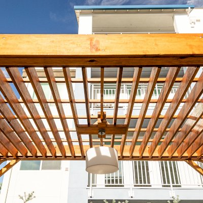 Silverado Modern Pergola (Options: 20' L, 12' W, Cantilevered Roof Style, Douglas-fir, 1 Electrical Wiring Trim, 7 1/4" x 7 1/4" Posts, No Privacy Panels, No Curtain Rods, 1 Ceiling Fan Base, 10' Post Height, Transparent Premium Sealant). Photo Courtesy of J. Holtfreter of San Jose, California.