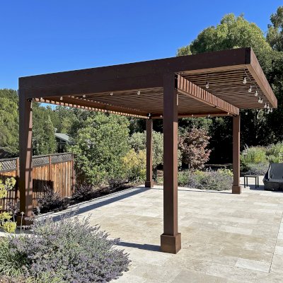 Silverado Modern Pergola (Options: 20' L, 15' W, Cantilevered Roof Style, California Redwood, No Electrical Wiring Trim, with 1 3/4" x 9 1/4" Roof Support Timbers and 7 1/4" x 7 1/4" Posts, Roof Rafter Spacing at 6", 4 Post Anchor Kit for High-Wind, No Privacy Panels, 3 Curtain Rods, 10' Post Height, Coffee-Stain Premium Sealant). Photo Taken 2 Years After Installation. Photo Courtesy of V. Weld of Morgan Hill, CA. 