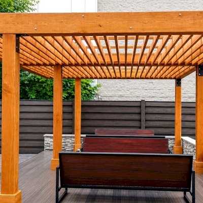 Silverado Modern Pergola (Options: 15' L, 22' W, Cantilevered Roof Style, Douglas-fir, No Electrical Wiring Trim, with 1 3/4" x 11 1/4" Roof Support Timbers and 7 1/4" x 7 1/4" Posts, Roof Rafter Spacing at 6", 6 Post Anchor Kit for High-Wind, No Privacy Panels, No Curtain Rods, 9' Post Height, Transparent Premium Sealant). Photo Courtesy of M. Zahler of Fort Lee, NJ.