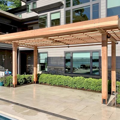 Silverado Modern Pergola (Options: 23' L, 9'-6" W, Cantilevered Roof Style, California Redwood, 1 Electrical Wiring Trim, 7 1/4" x 7 1/4" Posts, No Privacy Panels, 3 Curtain Rods, 1 Ceiling Fan Base, 10' Post Height, Unfinished-Customer will Stain on Site). Photo Courtesy of J. Maskill of Rockford, Michigan.