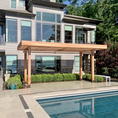 Silverado Modern Pergola (Options: 23' L, 9'-6" W, Cantilevered Roof Style, California Redwood, 1 Electrical Wiring Trim, 7 1/4" x 7 1/4" Posts, No Privacy Panels, 3 Curtain Rods, 1 Ceiling Fan Base, 10' Post Height, Unfinished-Customer will Stain on Site). Photo Courtesy of J. Maskill of Rockford, Michigan.
