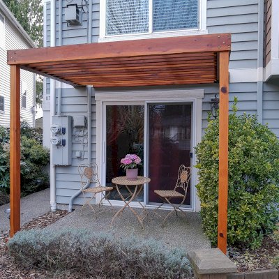 Custom Attached Silverado Modern Pergola (Options: 8' L, 8' W, 12" Roof Rafter Spacing, California Redwood, No Ceiling Fan Base, 2-Post Anchor kit for Concrete,Transparent Premium Sealant).