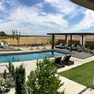 Silverado Modern Pergola (Options: 30'-8" L, 16' W, Cantilevered Roof Style, California Redwood, No Electrical Wiring Trim, with 1 3/4" x 11 1/4" Roof Support Timbers and 7 1/4" x 7 1/4" Posts, Roof Rafter Spacing at 6", 6 Post Anchor Kit for High-Wind, No Privacy Panels, No Curtain Rods, 10' Post Height, Coffee-Stain Premium Sealant). Photo Courtesy of B. Aronson of Lincoln, CA.