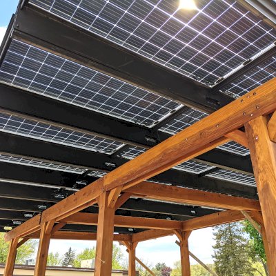 Solar Pergola (Options: 33' x 14', California Redwood, 8-Post Anchor Kit for High-Wind, Transparent Premium Sealant). Solar Panels Installed by Customer. Photo Courtesy of C. Couillard of Deerfield, Wisconsin.