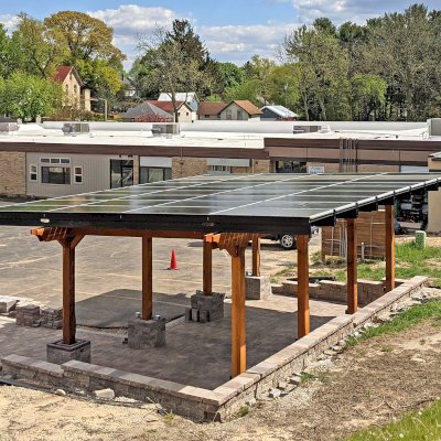 Solar Pergola (Options: 33' x 14', California Redwood, 8-Post Anchor Kit for High-Wind, Transparent Premium Sealant). Solar Panels Installed by Customer. Photo Courtesy of C. Couillard of Deerfield, Wisconsin.