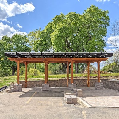 Solar Pergola (Options: 33' x 14', California Redwood, 8-Post Anchor Kit for High-Wind, Transparent Premium Sealant). Solar Panels Installed by Customer. Photo Courtesy of C. Couillard of Deerfield, Wisconsin.
