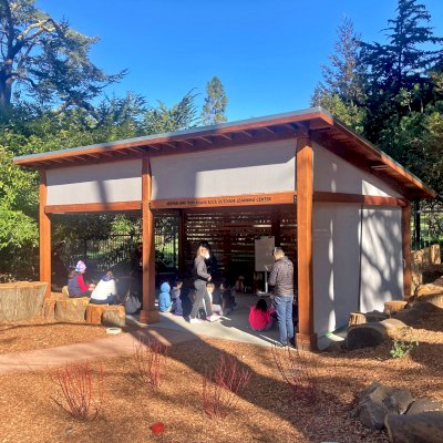 Custom Sunset Patio Pavilion (Options: 28' x 18', 1 Fixed Louvered Privacy Wall, California Redwood, No Electrical Wiring Trim, 6-Post Anchor Kit for High-Wind, No Post Decorative Trim, 9' & 12' H Posts, No Ceiling Fan Base, Curtain Rods on 3 Sides, with Fascia Boards, Transparent Premium Sealant). Supports and Rafters at Same Level by Custom Request. Photo Courtesy of California Academy of Sciences of San Francisco. CA [www.calacademy.org].