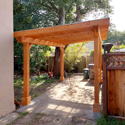 Custom Sunset Patio Pavilion (Options: 15' L x 10'-6" W, No Privacy Panels, Douglas-fir, No Electrical Wiring Trim, 4-Post Anchor Kit for Concrete, No Post Decorative Trim, with Transparent Polycarbonate Roofing Panels Instead of the Standard Roof Boards, No Ceiling Fan Base, No Curtain Rods, Transparent Premium Sealant). Photo Courtesy of L. Draper of Aptos, California.