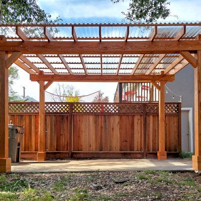 Custom Sunset Patio Pavilion (Options: 15' L x 10'-6" W, No Privacy Panels, Douglas-fir, No Electrical Wiring Trim, 4-Post Anchor Kit for Concrete, No Post Decorative Trim, with Transparent Polycarbonate Roofing Panels Instead of the Standard Roof Boards, No Ceiling Fan Base, No Curtain Rods, Transparent Premium Sealant). Photo Courtesy of L. Draper of Aptos, California.