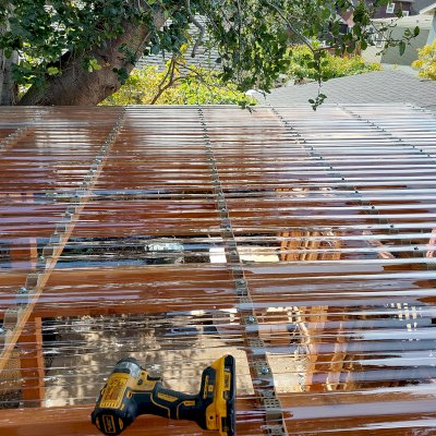 Custom Sunset Patio Pavilion (Options: 15' L x 10'-6" W, No Privacy Panels, Douglas-fir, No Electrical Wiring Trim, 4-Post Anchor Kit for Concrete, No Post Decorative Trim, with Transparent Polycarbonate Roofing Panels Instead of the Standard Roof Boards, No Ceiling Fan Base, No Curtain Rods, Transparent Premium Sealant). Photo Courtesy of L. Draper of Aptos, California.
