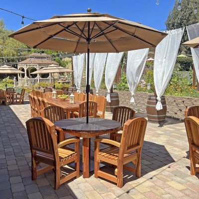 Sunset Patio Table (Options: 5.5' Diameter, With Chairs, Mosaic Redwood, 4 Luna Armchairs, No Cushions, Standard Tabletop, No Lazy Susan, 1 5/8" Umbrella Hole, Transparent Premium Sealant). Photo Also Shows a San Francisco Patio Table Set and a Round Patio Table Set in Background. Photo Courtesy of J. Newman of Carmel Valley, CA.