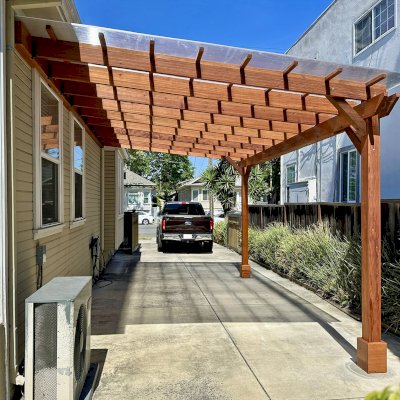 Custom Sunset Porch Pavilion (Options: 20' L x 12' W, Mature Redwood, No Electrical Wiring Trim, 2-Post Anchor Kit for Concrete, 10' H Posts, No Post Decorative Trim, with Transparent Polycarbonate Roofing Panels Instead of the Standard Roof Boards, No Ceiling Fan Base, No Curtain Rods, Transparent Premium Sealant). Photo Courtesy of M. Bualat of San Jose, CA.