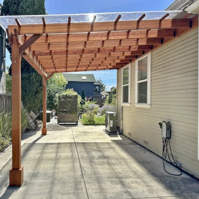 Custom Sunset Porch Pavilion (Options: 20' L x 12' W, Mature Redwood, No Electrical Wiring Trim, 2-Post Anchor Kit for Concrete, 10' H Posts, No Post Decorative Trim, with Transparent Polycarbonate Roofing Panels Instead of the Standard Roof Boards, No Ceiling Fan Base, No Curtain Rods, Transparent Premium Sealant). Photo Courtesy of M. Bualat of San Jose, CA.