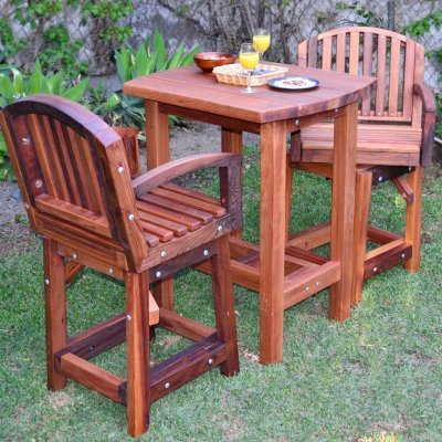 The Tete-a-Tete Outdoor Wood Cocktail & Bar Stool Set (Options: Vera's Armchair, Mature Redwood, with Swivels, No Cushions, Standard Tabletop, No Umbrella Hole, Transparent Premium Sealant). 