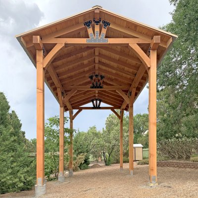 Thick Timber Toledo Wood Pavilion  (Options: 24' L x 14' W, Douglas-fir, 6-Post Anchor Kit High-Wind, No Electrical Wiring Trim, 8 x 8 Supports and Posts, 8 x 8 Rafters,12' H Posts, No Fan Base, Transparent Premium Sealant). This is an example of one way to design and build a pavilion when the ground is uneven. Photo Courtesy of J. Loessner of Albuquerque, New Mexico.