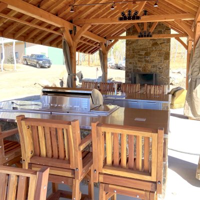 Thick Timber Toledo Wood Pavilion (Options: 50' L x 24' W, Douglas-fir, 8-Post Anchor Kit for High-Wind, with Curtain Rods, Electrical Wiring Trim for 4 Posts, 10 x 10 Supports and Posts, 8 x 8 Rafters, Transparent Premium Sealant). Custom 4' Overhang on All Sides (Standard Overhang is 1'). Photo Courtesy of R. Barry of Hayden, Colorado.