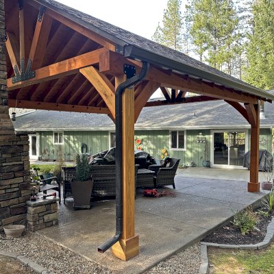 Thick Timber Toledo Wood Pavilion (Options: 20' L x 20' W, Douglas-fir, 4-Post Anchor Kit for Concrete, 8' H Posts, No Electrical Wiring Trim, 8 x 8 Posts and Trusses, 8 x 10 Supports, 2 x 8 Rafters, No Fan Bases, Transparent Premium Sealant). Photo Courtesy of B. Read of Grants Pass, Oregon.