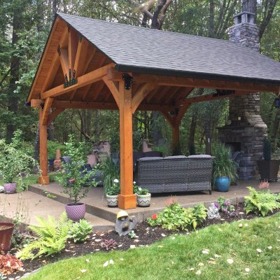 Thick Timber Toledo Wood Pavilion (Options: 20' L x 20' W, Douglas-fir, 4-Post Anchor Kit for Concrete, 8' H Posts, No Electrical Wiring Trim, 8 x 8 Posts and Trusses, 8 x 10 Supports, 2 x 8 Rafters, No Fan Bases, Transparent Premium Sealant). Photo Courtesy of B. Read of Grants Pass, Oregon.