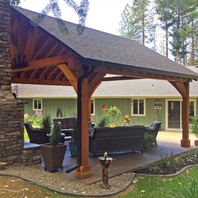 Thick Timber Toledo Wood Pavilion (Options: 20' L x 20' W, Douglas-fir, 4-Post Anchor Kit for Concrete, 8' H Posts, No Electrical Wiring Trim, 8 x 8 Posts and Trusses, 8 x 10 Supports, 2 x 8 Rafters, No Fan Bases, Transparent Premium Sealant). Photo Courtesy of B. Read of Grants Pass, Oregon.