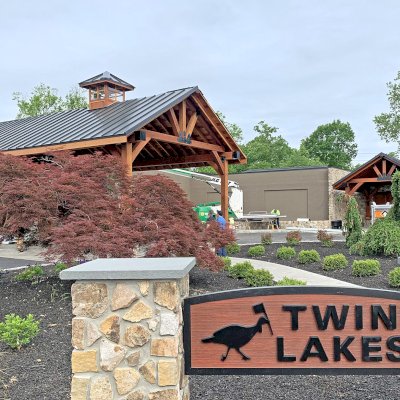 Thick Timber Toledo Wood Pavilions  (Options: 44' L x 25' W, California Redwood, 6-Post Anchor Kit for High-Wind, Electrical Wiring Trim for All Posts, 10 x 12 Supports, 8 x 10 Bottom Chord 8 x 8 Top Chords (Rafters), 10 x 10 Posts, 2 Fan Bases, with Custom Cupola and Metal Caps for All End Cuts, Transparent Premium Sealant). Photo Shows a 21' L x 20' W Toledo Pavilion in Background. Photo Courtesy of G. Souillard of Allentown, Pennsylvania.