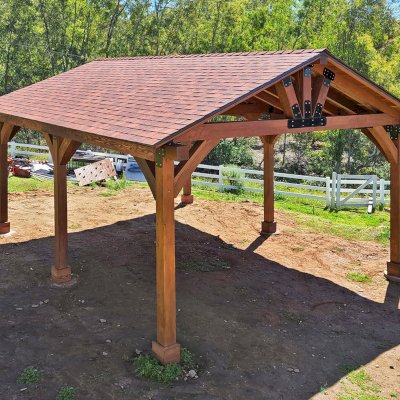 Thick Timber Toledo Wood Pavilion (Options: 24' L x 20' W, Douglas-fir, 6-Post Anchor Kit for High-Wind, 9.5' H Posts, 1 Electrical Wiring Trim, 8 x 8 Supports and Posts, 8 x 8 Rafters, 2 Fan Bases, 5/12 Pitch, Transparent Premium Sealant). Photo Courtesy of T. Houston of Poway,CA.
