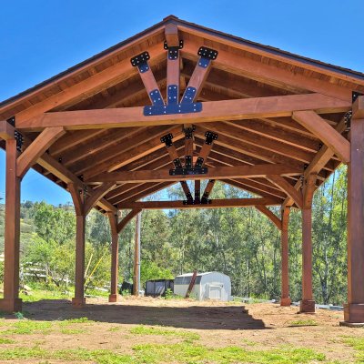 Thick Timber Toledo Wood Pavilion (Options: 24' L x 20' W, Douglas-fir, 6-Post Anchor Kit for High-Wind, 9.5' H Posts, 1 Electrical Wiring Trim, 8 x 8 Supports and Posts, 8 x 8 Rafters, 2 Fan Bases, 5/12 Pitch, Transparent Premium Sealant). Photo Courtesy of T. Houston of Poway,CA.