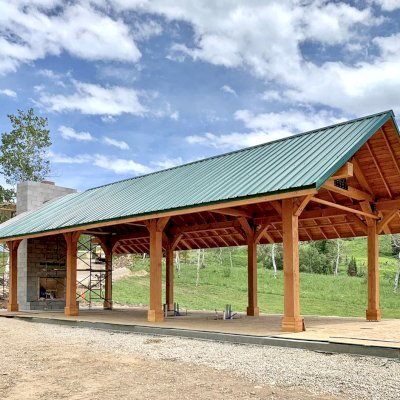 Thick Timber Toledo Wood Pavilion (Options: 50' L x 24' W, Douglas-fir, 8-Post Anchor Kit for High-Wind, with Curtain Rods, Electrical Wiring Trim for 4 Posts, 10 x 10 Supports and Posts, 8 x 8 Rafters, Transparent Premium Sealant). Custom 4' Overhang on All Sides (Standard Overhang is 1'). Photo Courtesy of R. Barry of Hayden, Colorado.