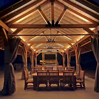 Thick Timber Toledo Wood Pavilion (Options: 50' L x 24' W, Douglas-fir, 8-Post Anchor Kit for High-Wind, with Curtain Rods, Electrical Wiring Trim for 4 Posts, 10 x 10 Supports and Posts, 8 x 8 Rafters, Transparent Premium Sealant). Custom 4' Overhang on All Sides (Standard Overhang is 1'). Photo Courtesy of R. Barry of Hayden, Colorado.