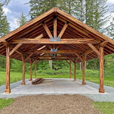 Thick Timber Toledo Wood Pavilion Under Installation (Options: 44' L x 26' W, Mosaic California Redwood, with 3 Skylights, 9.5' H Posts, 8x8 Posts, with 2 Ceiling Fan Bases, Electrical Wiring Trim Kit for 6 Posts, Transparent Premium Sealant). Photo Courtesy of S. Pud of Monroe, WA.