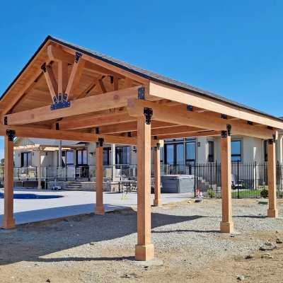 Custom Thick Timber Toledo Wood Pavilion (Options: 26' L x 18' W, Douglas-fir, 6-Post Anchor Kit for High-Wind, No Curtain Rods, No Electrical Wiring Trims, 8 x 12 Supports and Bottom Chord, 8 x 8 Posts, 2 x 6 Dual Top Chord [Rafters] with Blockings, Sherwin Williams Stain by Custom Request). Photo Courtesy of D. Armstrong of Gardnerville, NV.