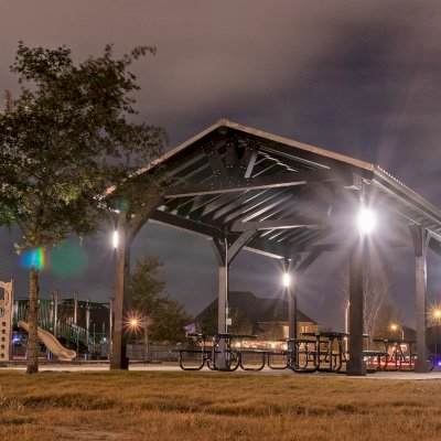 Thick Timber Toledo Wood Pavilion (Options: 30' L x 18' W, Douglas-fir, 6-Post Anchor Kit for High-Wind, No Curtain Rods, 1 Electrical Wiring Trim, 8 x 8 Supports, Rafters and Posts, Black Stain Premium Sealant). Photo Courtesy of T. Harris of Katy, TX.
