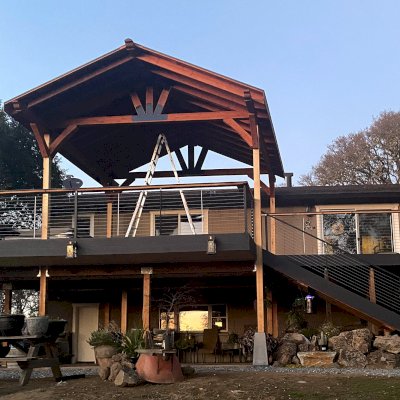 Custom Thick Timber Toledo Wood Pavilion (Options: 20' L x 18' W, Mature Redwood, No Anchors, No Curtain Rods, No Electrical Wiring Trim, 6 x 8 Supports and 2 x 8 Rafters, 4' Front Overhang by Custom Request, 1 Ceiling Fan Base, Transparent Premium Sealant). Roof Installed On Existing Posts. Photo Courtesy of J. Schmidt of Ukiah, CA.