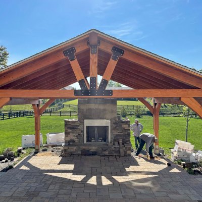 Thick Timber Toledo Wood Pavilion (Options: 22' L x 22' W, Douglas-fir, 4-Post Anchor Kit for High-Wind, No Electrical Wiring Trim, 8 x 8 Supports and Posts, 8 x 8 Rafters, No Fan Base, Transparent Premium Sealant). Chimney Under Construction. Photo Courtesy of M. Lazhar of Ashburn, Virginia.
