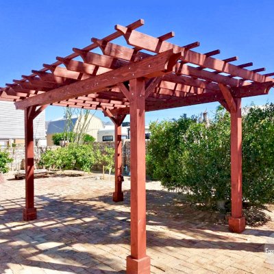 Traditional Wooden Garden Pergola (Options: 16' L x 12' W, California Redwood, No Electrical Wiring Trim, Open Roof with Slats at 18", Rafters at 18", 4-Post Anchor Kit for High-Wind, No Ceiling Fan Base, No Privacy Panels, No Curtain Rods, 9' Post Height, Cherry Stain Premium Sealant). Photo Courtesy of N. Miller of Yuma, Arizona.