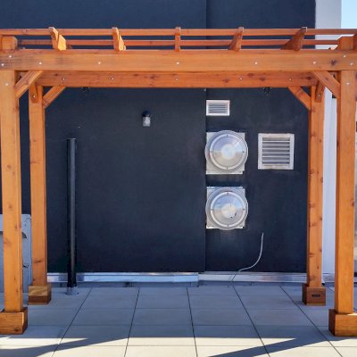 Traditional Wooden Garden Pergola (Options: 12' L x 6' W, California Redwood, No Electrical Wiring Trim, Lengthwise Roof Support, Open Roof with Slats at 18", Rafters at 18", 4-Post Anchor Kit for Concrete, No Ceiling Fan Base, No Privacy Panels, No Curtain Rods, 9' Post Height, Transparent Premium Sealant). Photo Courtesy of Abe G. of Brooklyn, NY.