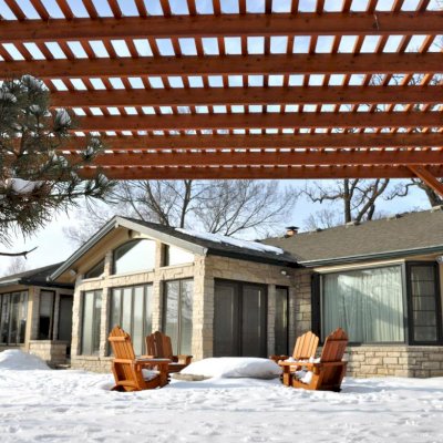 Traditional Wooden Garden Pergola (Options: 20' L x 14' W, Mature Redwood, No Electrical Wiring Trim, Slats at 6" and Rafters at 18", Lengthwise Roof Support Timbers, 4-Post Anchor Kit for Stone, No Ceiling Fan Base, No Privacy Panels, No Curtain Rods, 9' Post Height, Transparent Premium Sealant). Photo Courtesy of Mary Louise and Gerry Neugent of Des Moines, IA.
